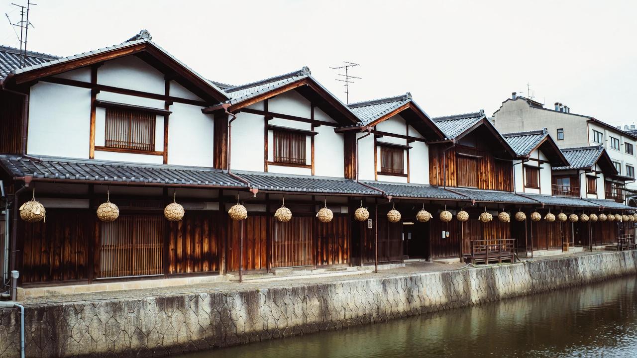 Narrow Pontocho alley lit by paper lanterns with traditional restaurant facades